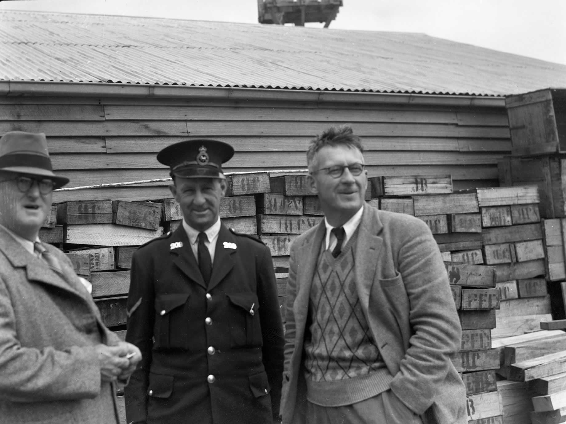 Local policeman chatting with locals at the wharf in Stanley